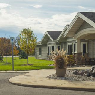 A suburban house with a well-maintained lawn and driveway.