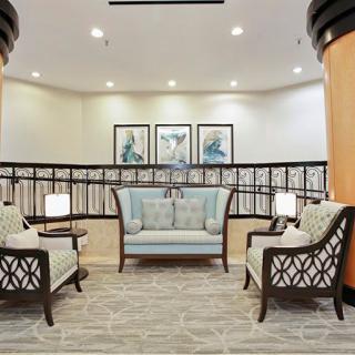 A modern lounge area with stylish seating and decorative artwork on the walls.