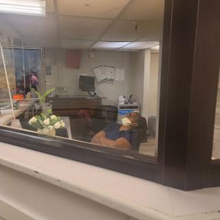 A view through a window into a hospital waiting area.