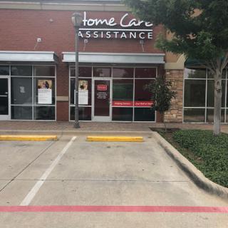 Exterior view of a Home Care Assistance office, showcasing the entrance and parking area.