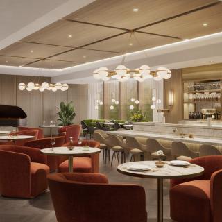 A modern and elegant restaurant interior with a bar and comfortable seating.