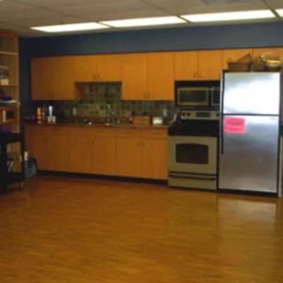 A kitchen with wooden cabinets, stainless steel appliances, and a clean countertop.