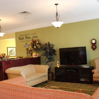 A cozy living room featuring comfortable seating, a television, and tasteful decor.