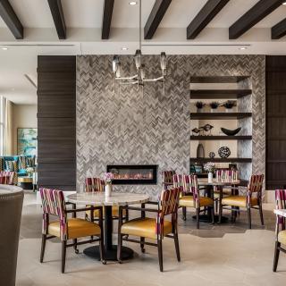 A modern restaurant interior with stylish seating arrangements and a cozy fireplace.