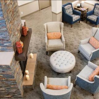 A stylish and comfortable living room with modern chairs and a central coffee table.