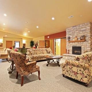 A cozy living room featuring patterned sofas, a fireplace, and elegant decor.