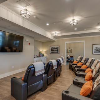 A cozy home theater with comfortable recliner seating and a large screen for entertainment.