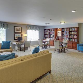 A cozy living room with bookshelves and a comfortable seating area.