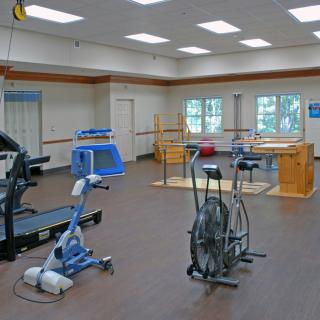 A rehabilitation gym equipped with various exercise machines.
