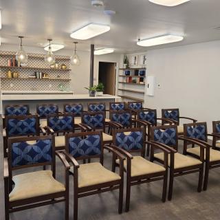 A well-arranged seating area with patterned chairs facing a countertop bar.