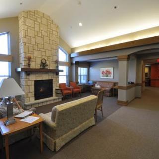 A cozy living room with a fireplace, designed for relaxation and comfort.
