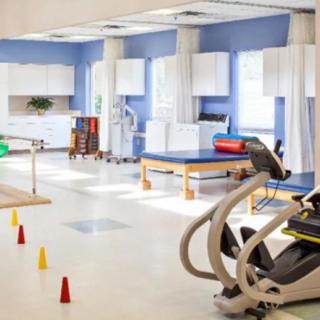 A rehabilitation room equipped with various physical therapy equipment.