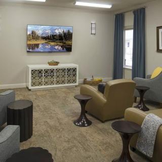 A cozy living room with a television, comfortable seating, and tasteful decor.