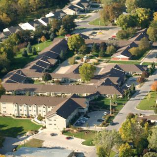 Aerial view of a residential building complex surrounded by greenery.
