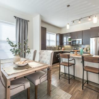A modern open-plan kitchen and dining area with stylish furnishings.