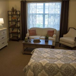 A cozy bedroom with comfortable seating and stylish decor.