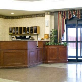 A hotel lobby with a reception desk and entrance area.