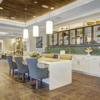 A modern kitchen with an island counter and stylish pendant lighting.