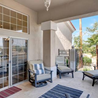 A cozy patio with comfortable chairs and colorful rugs, perfect for outdoor relaxation.