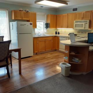 A cozy kitchen with wooden cabinets and modern appliances.