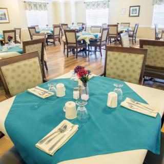 A neatly arranged dining area with tables set for guests.