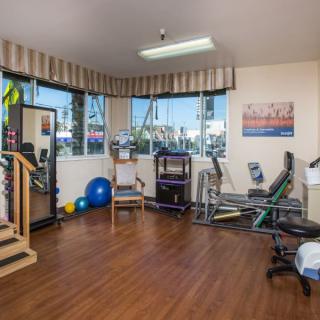 A well-equipped indoor gym with various exercise machines and equipment for fitness and rehabilitation.