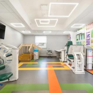 A bright and modern therapy center equipped with various exercise machines.