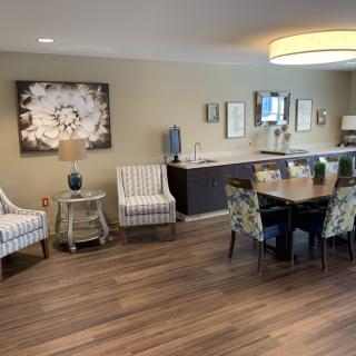 A modern dining room with wood flooring and stylish decor.