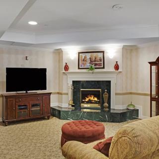 A cozy living room featuring a fireplace, television, and comfortable seating.