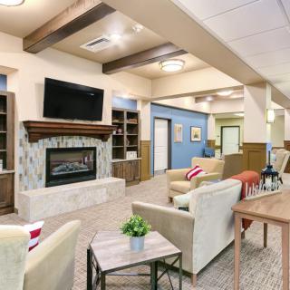A modern living room with comfortable seating, a fireplace, and a television.