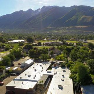 A scenic view of a rural area with mountains in the background.