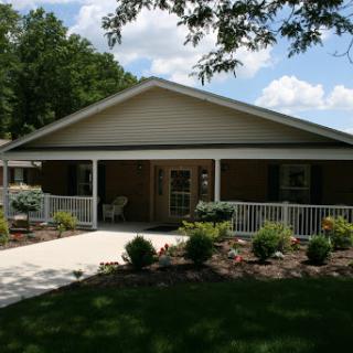 A welcoming single-story house with a landscaped front yard and a covered porch.