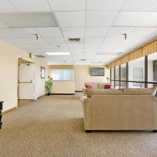 A spacious lobby with comfortable seating and large windows.