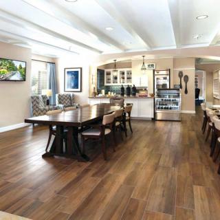 Modern kitchen and dining area with hardwood floors and open layout.