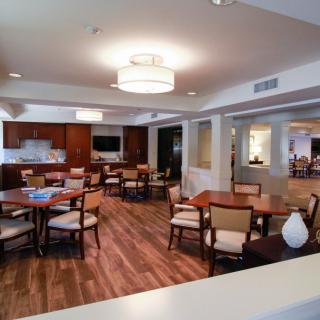 A modern dining area with wooden floors and contemporary furniture.