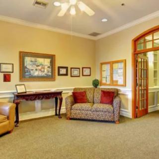 A cozy lobby area with comfortable seating and artwork on the walls.