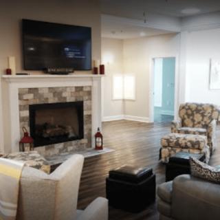 A cozy living room with a fireplace and modern decor.