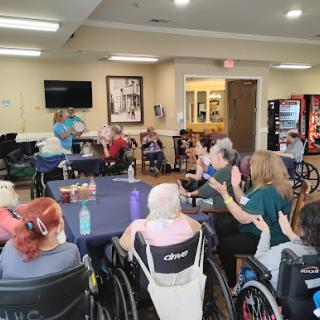 Residents engaging in a community activity at a nursing home.