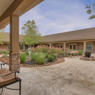 A peaceful courtyard with well-maintained landscaping and seating areas.
