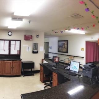 A reception area with desks, computers, and colorful ceiling decorations.