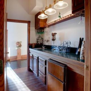 A cozy kitchen with wooden cabinets and warm lighting.