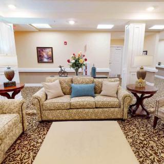 A well-decorated living room with patterned sofas, a rug, and various decorative elements.