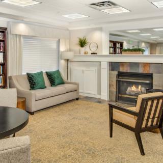 A cozy living room with a modern fireplace, comfortable seating, and stylish decor.