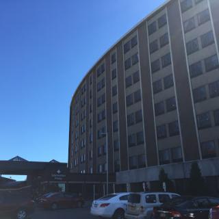 A modern hotel building under a clear blue sky.