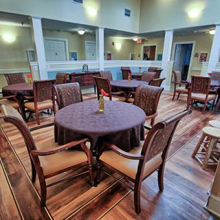 A well-decorated dining room with multiple tables and chairs.