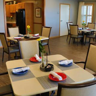 A cozy dining area set up for a meal, featuring decorated tables and a welcoming atmosphere.