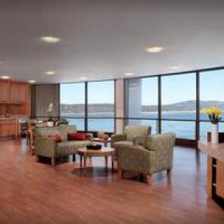 A spacious living room with large windows offering a scenic view.