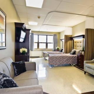 A modern hospital room with comfortable furniture and a welcoming atmosphere.