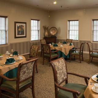 An elegantly decorated dining room with set tables and chairs, ready for guests.
