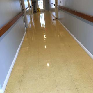 A clean and shiny hallway with polished floors.